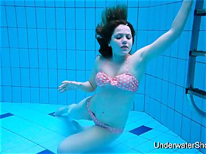 handsome lady demonstrates marvelous assets underwater